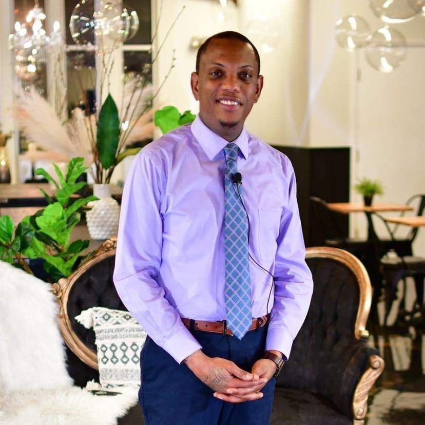 About Us! Jerry Filmore CEO of Whats Up Worcester in a purple shirt and tie